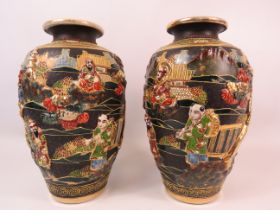 Pair of Japanese 3D relief Satsuma vases with character mark to the base, 25cm tall.