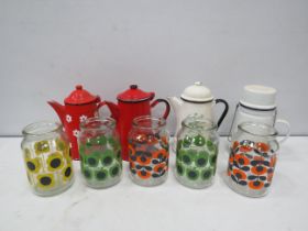 Selection of enamel teapots and retro style storage jars.