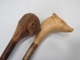 Two Naturalistic Walking Canes with Carved Handles , One shaped as a Hedgehog (32 inches) one as a S