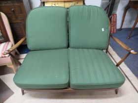 Ercol Dark wood two seater settee in good order with seat pads. See photos