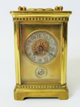 Brass Carriage clock with alarm,  glass panels and door. Enamel dial. Working order.   Requires key.