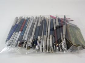 Bag of Mainly Parker ballpoint pens.