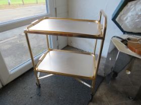 Gold metal retro tray trolley with two detachable trays.