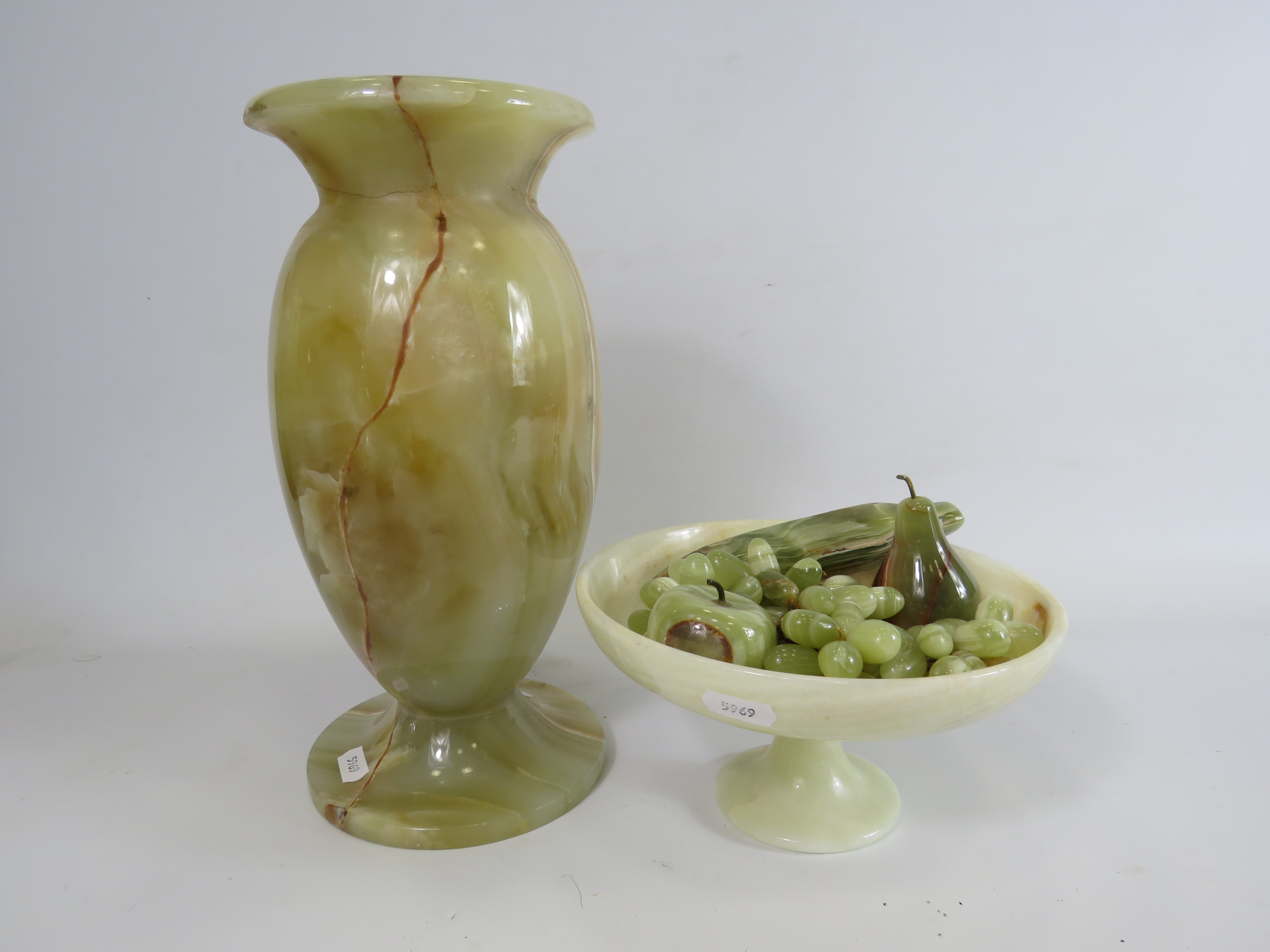 Large onyx vase and a pedastal bowl with a selection of fruit.