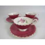 3 Susie Cooper pink cabinet cups and saucers with floral decoration to the bowl.