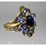 9ct Yellow Gold Ring set with Purple Gemstones in a flower pattern.  Finger size 'O-5 to P'     4.5g