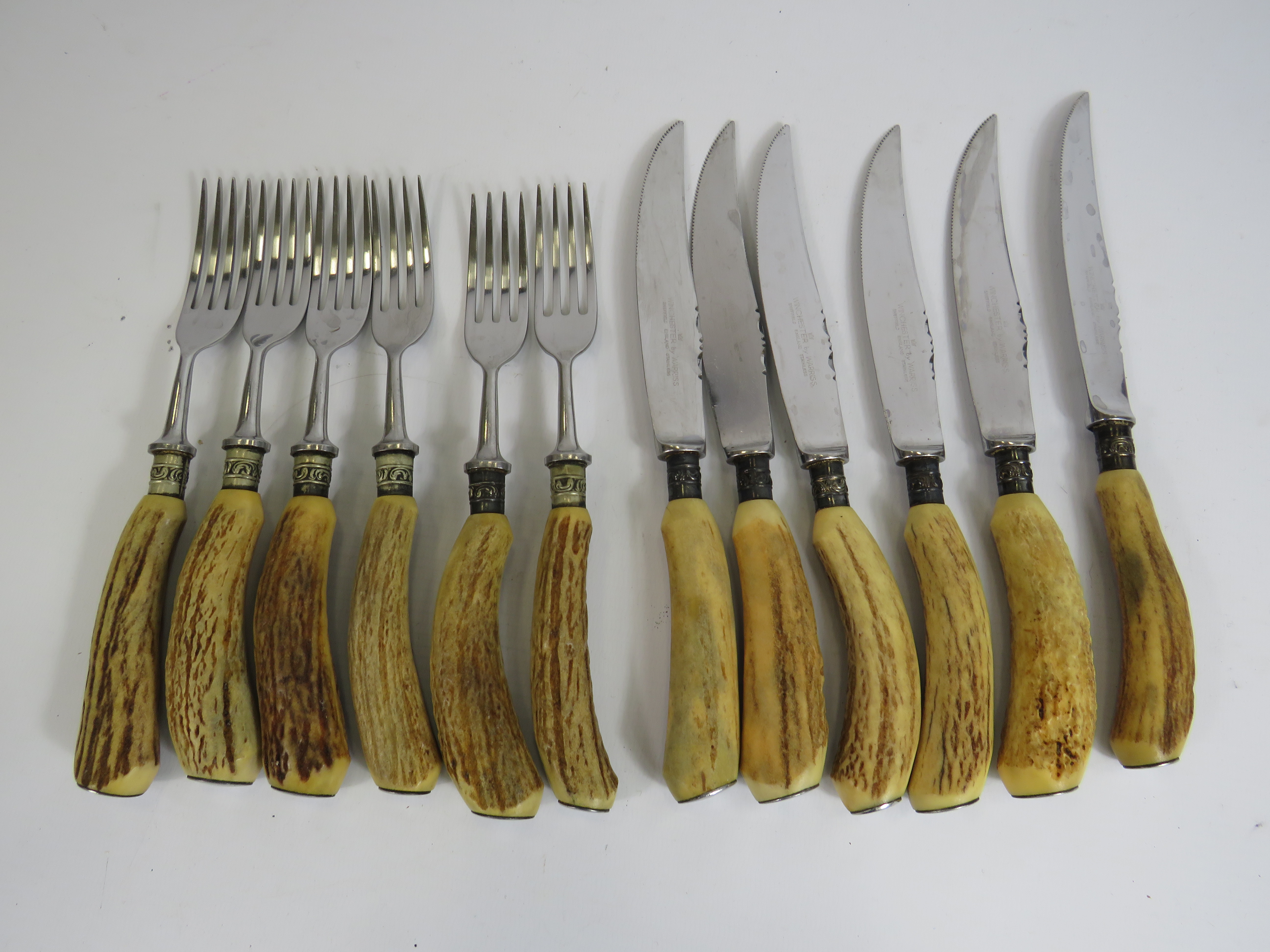 Set 6 of Antler handle knives and forks.