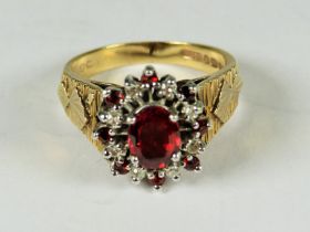 Very Large 9ct Yellow Gold ring set with a central Garnet with Diamond Cluster surround. Finger siz