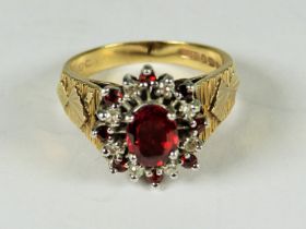 Very Large 9ct Yellow Gold ring set with a central Garnet with Diamond Cluster surround.  Finger siz