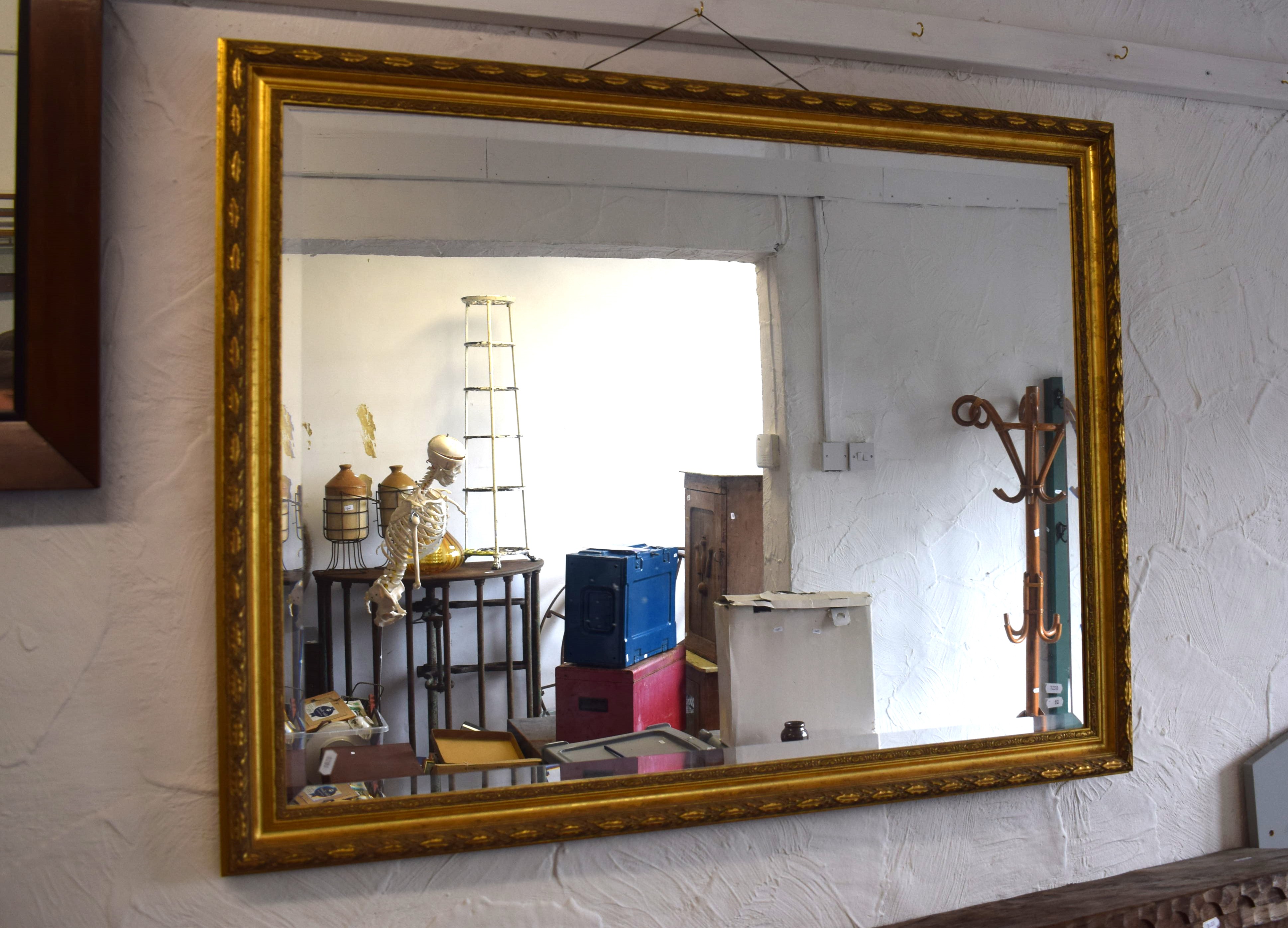 Oblong Bevelled edge mirror with gilt wood frame.   Measures approx 34 x 44 inches. See photos.  S2