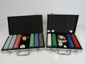 2 White metal cases containing casino chips.