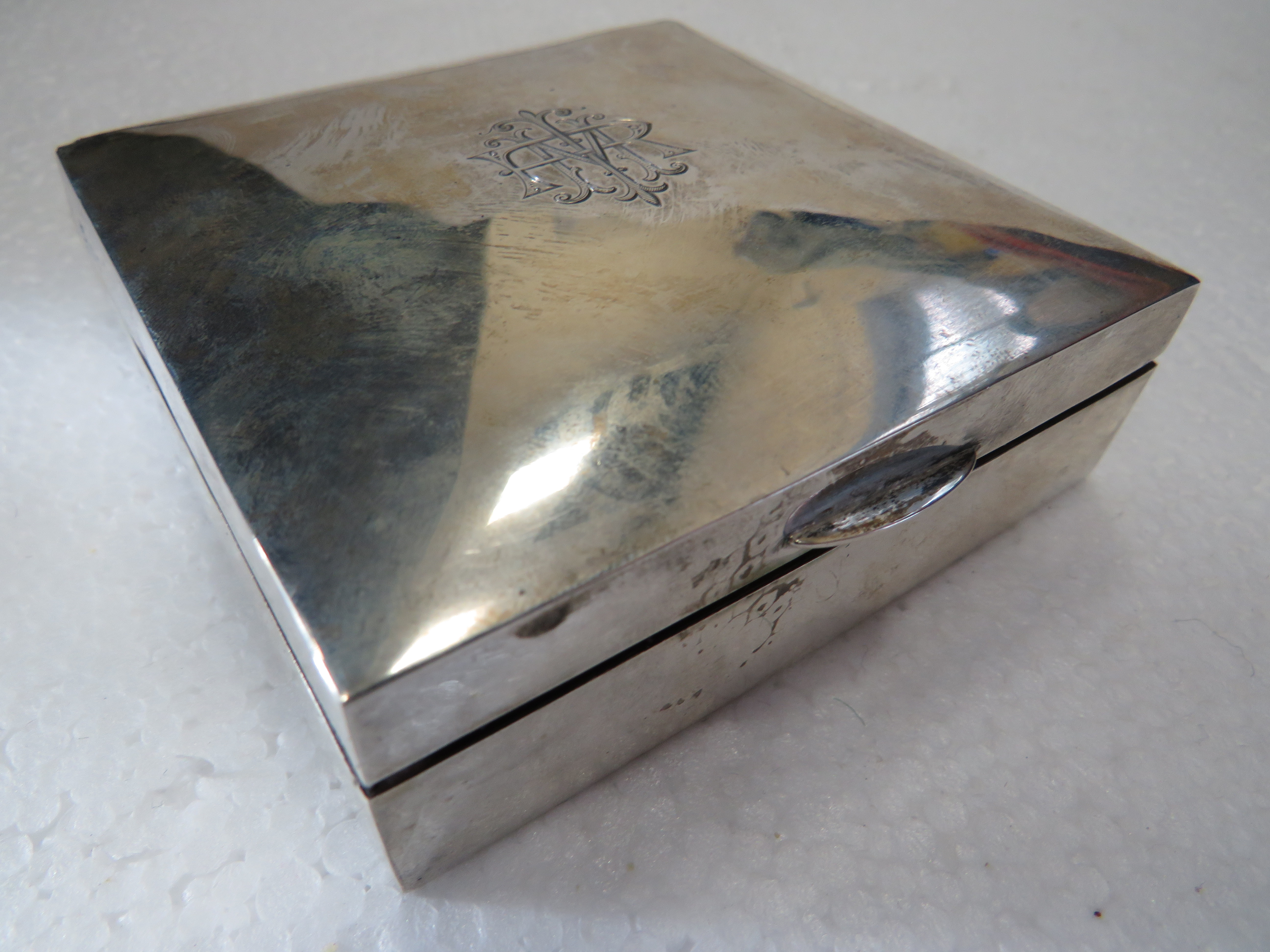 Hallmarked Silver Cigarette box with cedar wood interior. Engraved initials to hinged lid.  Measures