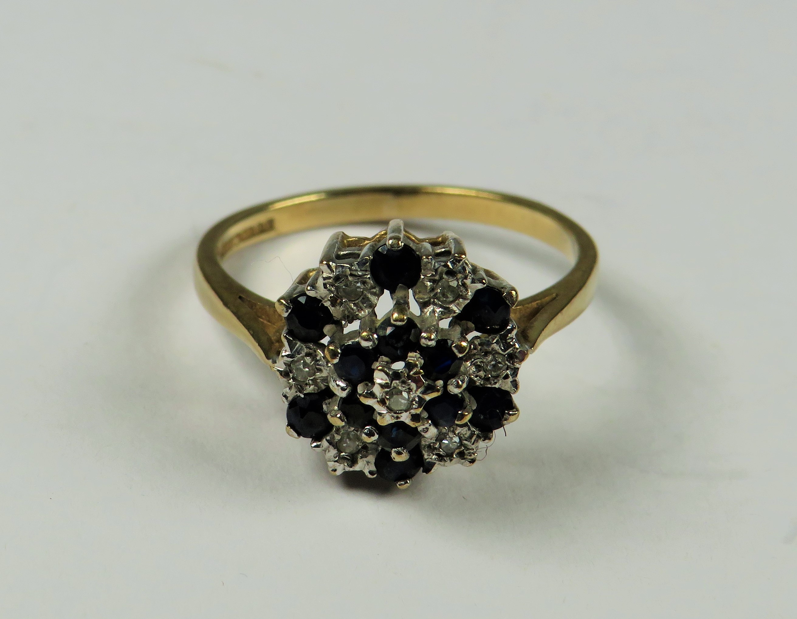 9ct Yellow Gold Diamond as Sapphire ring set in a Flower pattern.   Finger size 'M-5'   2.4g