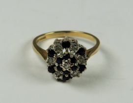 9ct Yellow Gold Diamond as Sapphire ring set in a Flower pattern. Finger size 'M-5' 2.4g