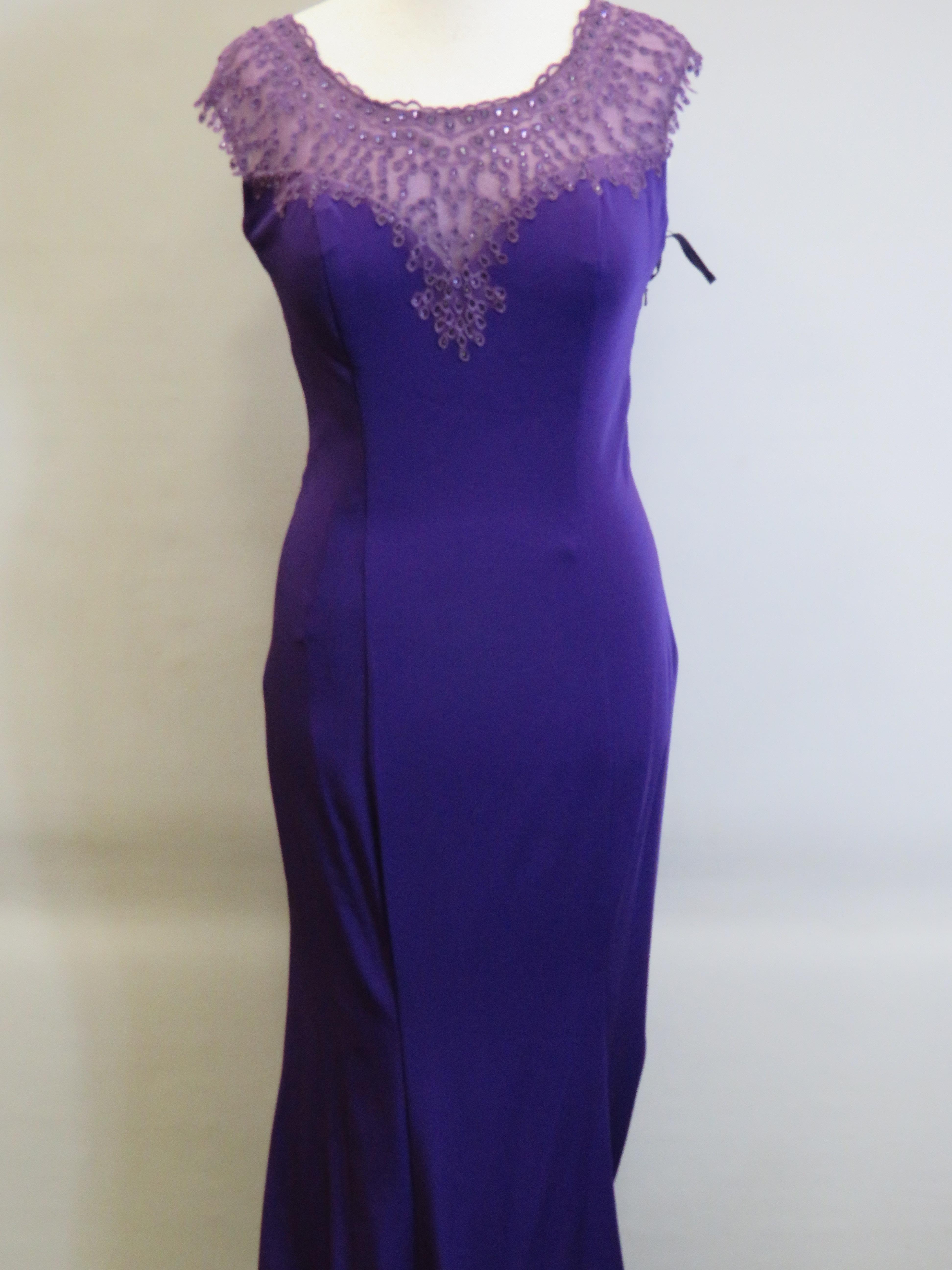 As New and unused Prom Dress or Ball Gown by Crystal Breeze in Purple. Side zip. UK size 14.  See ph