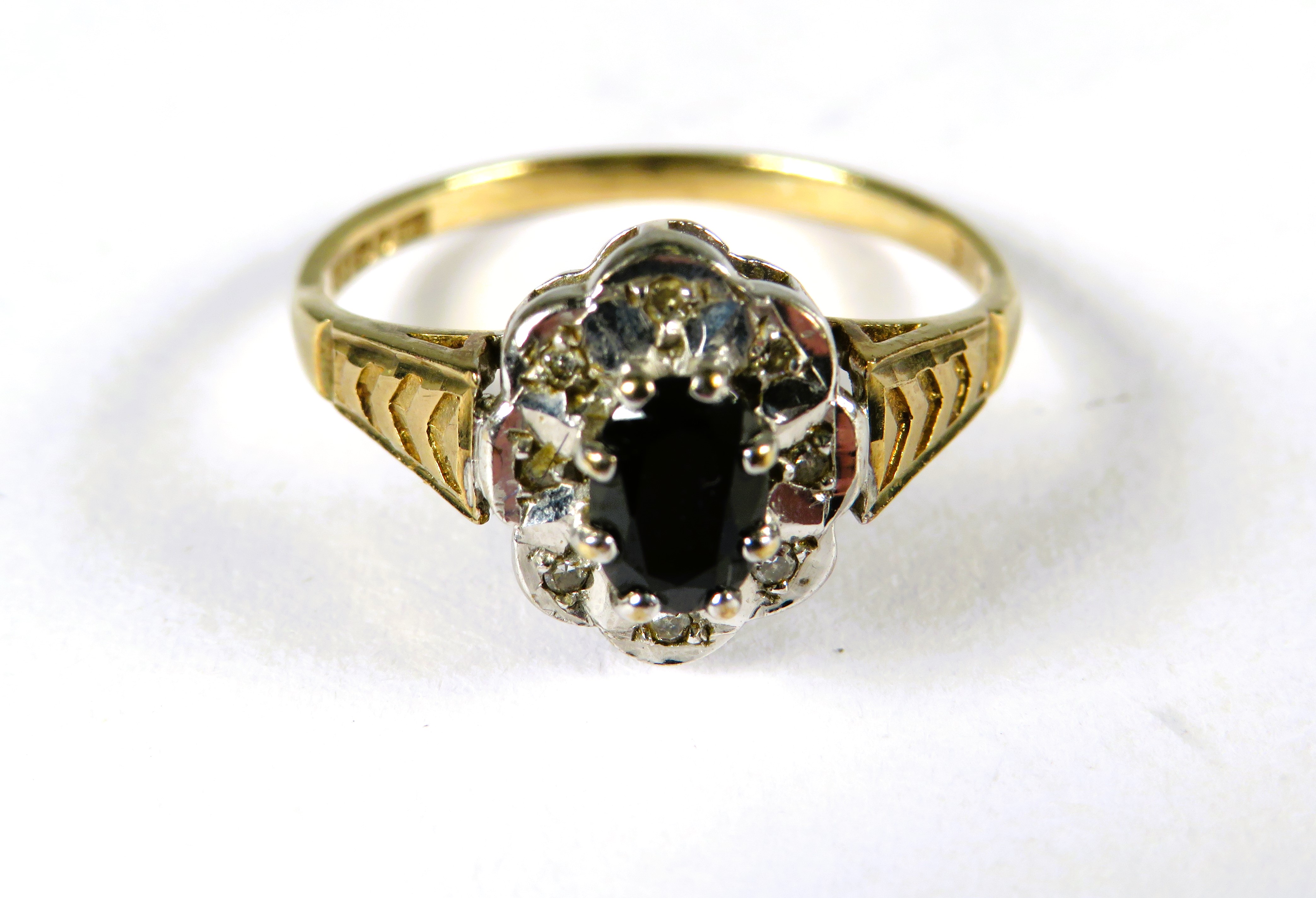 9ct Yellow Gold Ring set with a Central Sapphire with small diamond set surround .  Finger size 'N-5