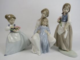 3 Nao figurines, 2 of Girls with flowers and 1 of a mother and child, the tallest measures 23cm (