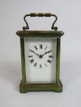 Pretty Brass Cased Carriage Clock with Key, enamel face. Running order 4.5 inches tall. ( door opens