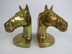 2 Brass horse head book ends, 16cm tall and 13cm by 9cm.