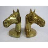 2 Brass horse head book ends, 16cm tall and 13cm by 9cm.