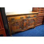 Large buffet cabinet with carving decoration to front. Two drawers above cupboards.  See photos. 