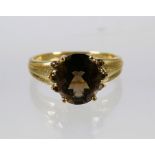 9ct Yellow Gold Ring set with a Smokey quartz (10 x 8mm ) with Melee Diamonds to shoulders. Finger s