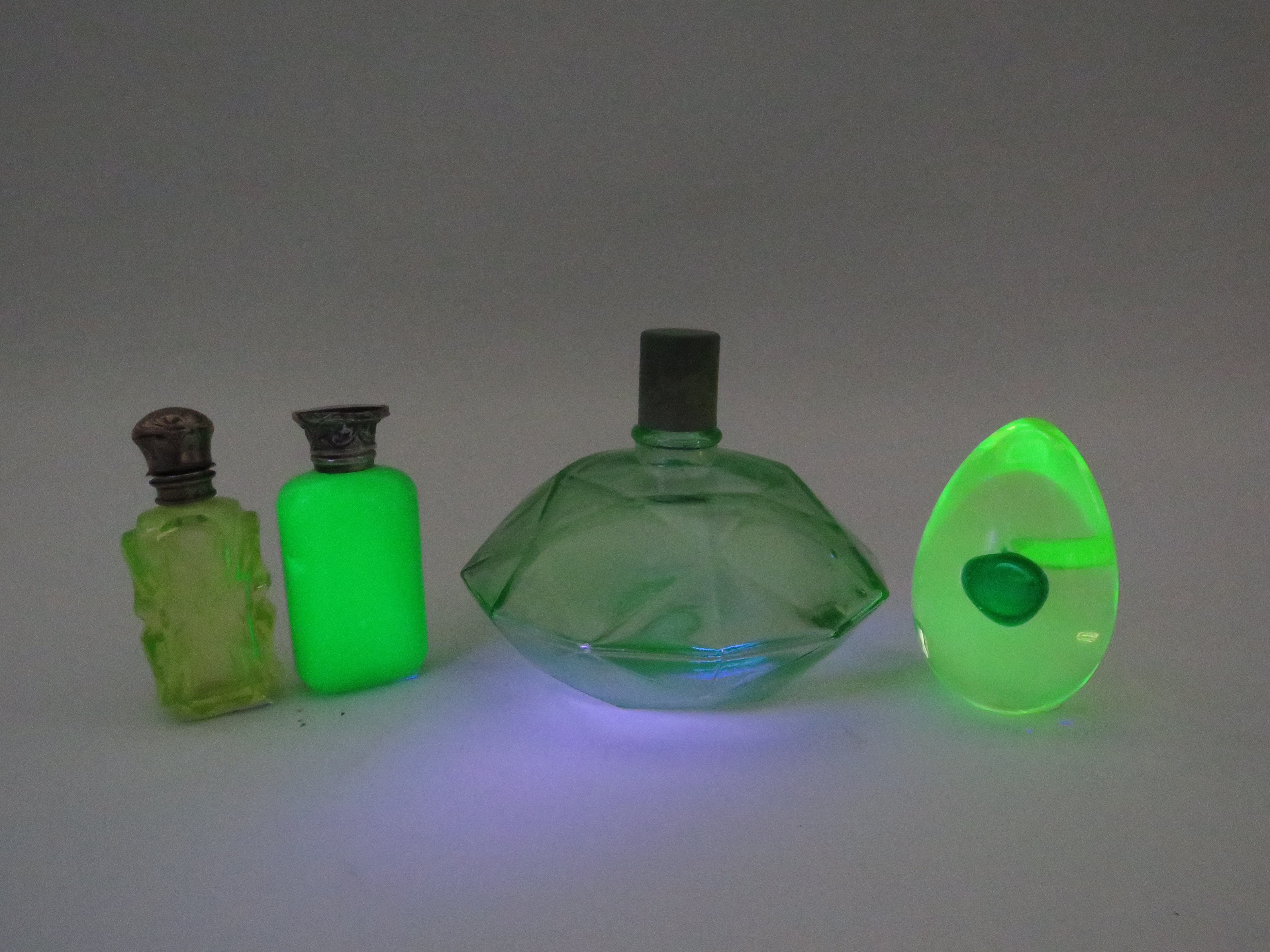 3 Uranium glass scent bottles and a paperweight by Murano.