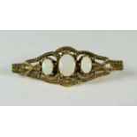 9ct Yellow Gold Bar Brooch set with Three oval Opals with gold pin.  Measures 40mm long.  Weight 4.0