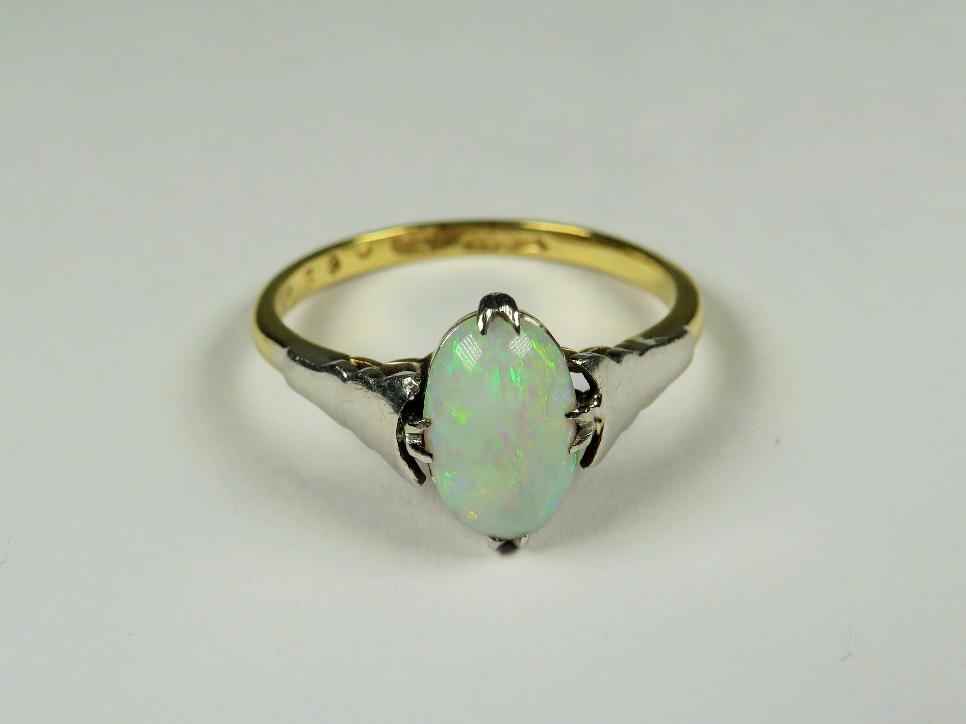 18ct Yellow Gold ring set with a lovely Oval Opal supported by Platinum shoulders.  Finger size 'P' 