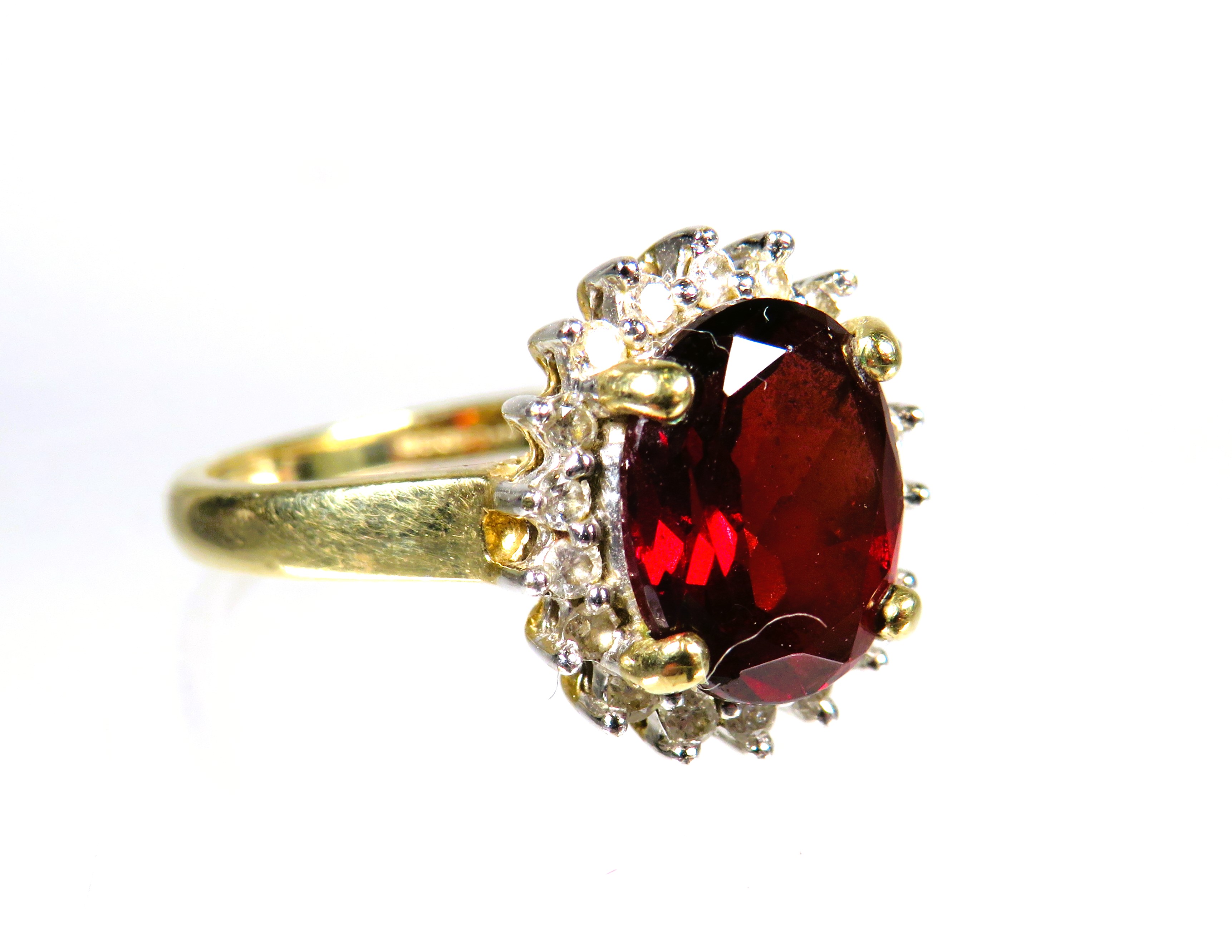 9ct Yellow Gold ring set with a large Oval Garnet which measures approx 10 x 8 mm with Diamond Surro - Image 2 of 3