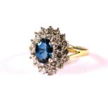 Very Pretty 9ct Yellow Gold ring set with a Central Oval shaped Sapphire and Tiny Diamonds surroundi