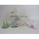 Five art glass figurines on mirrored bases and a lattice glass wheel barrow,