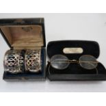 Pair of Gold tone spectacles with original case plus a pair of Hallmarked Silver pierced Napkin ring