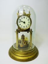 German made brass Anniversary clock under Glass dome. Appears to be in running order. Small piece