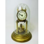 German made brass Anniversary clock under Glass dome. Appears to be in running order. Small piece