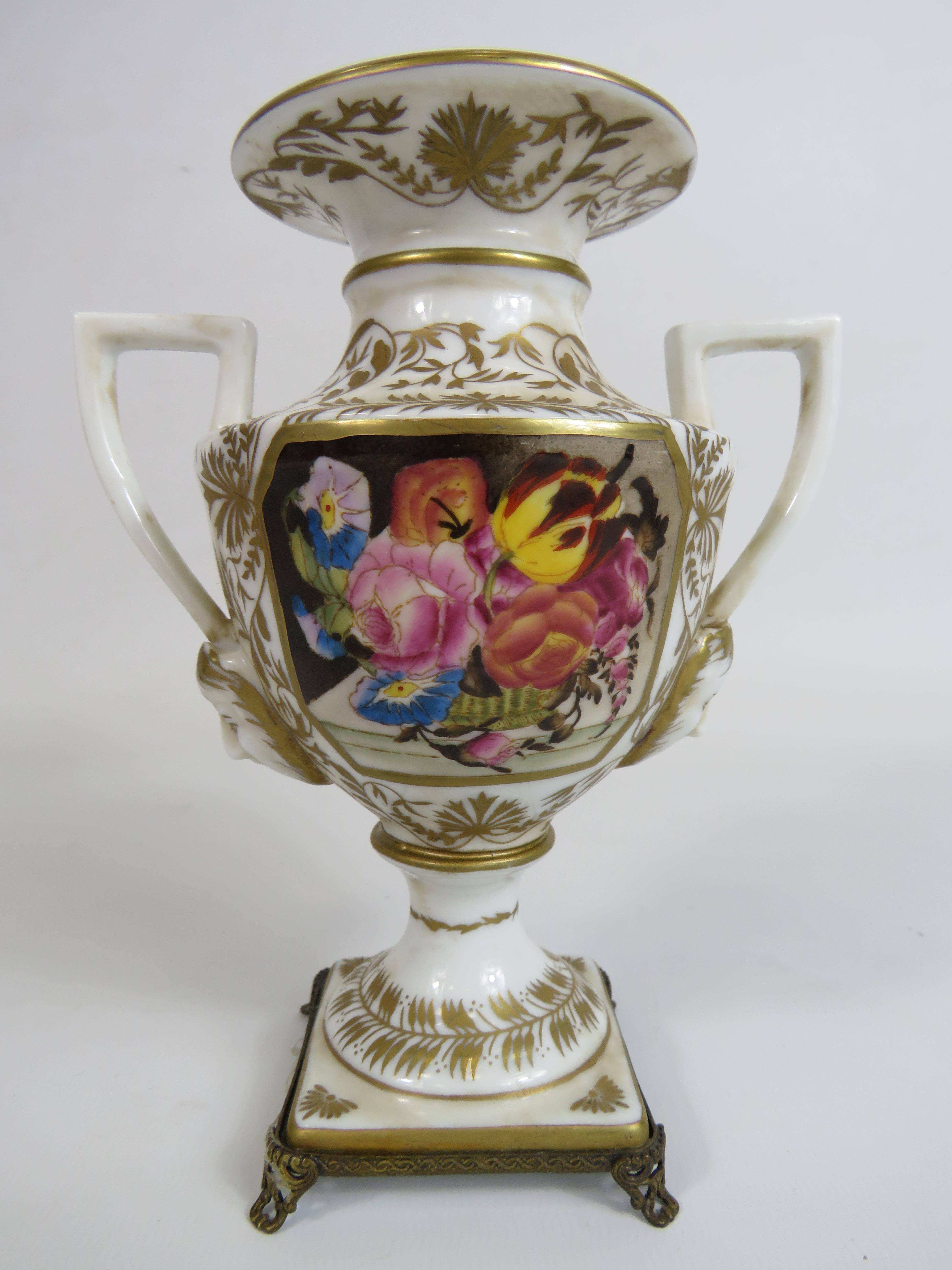 Meissen style twin handle vase sitting on brass feet, 16cm tall.