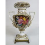 Meissen style twin handle vase sitting on brass feet, 16cm tall.