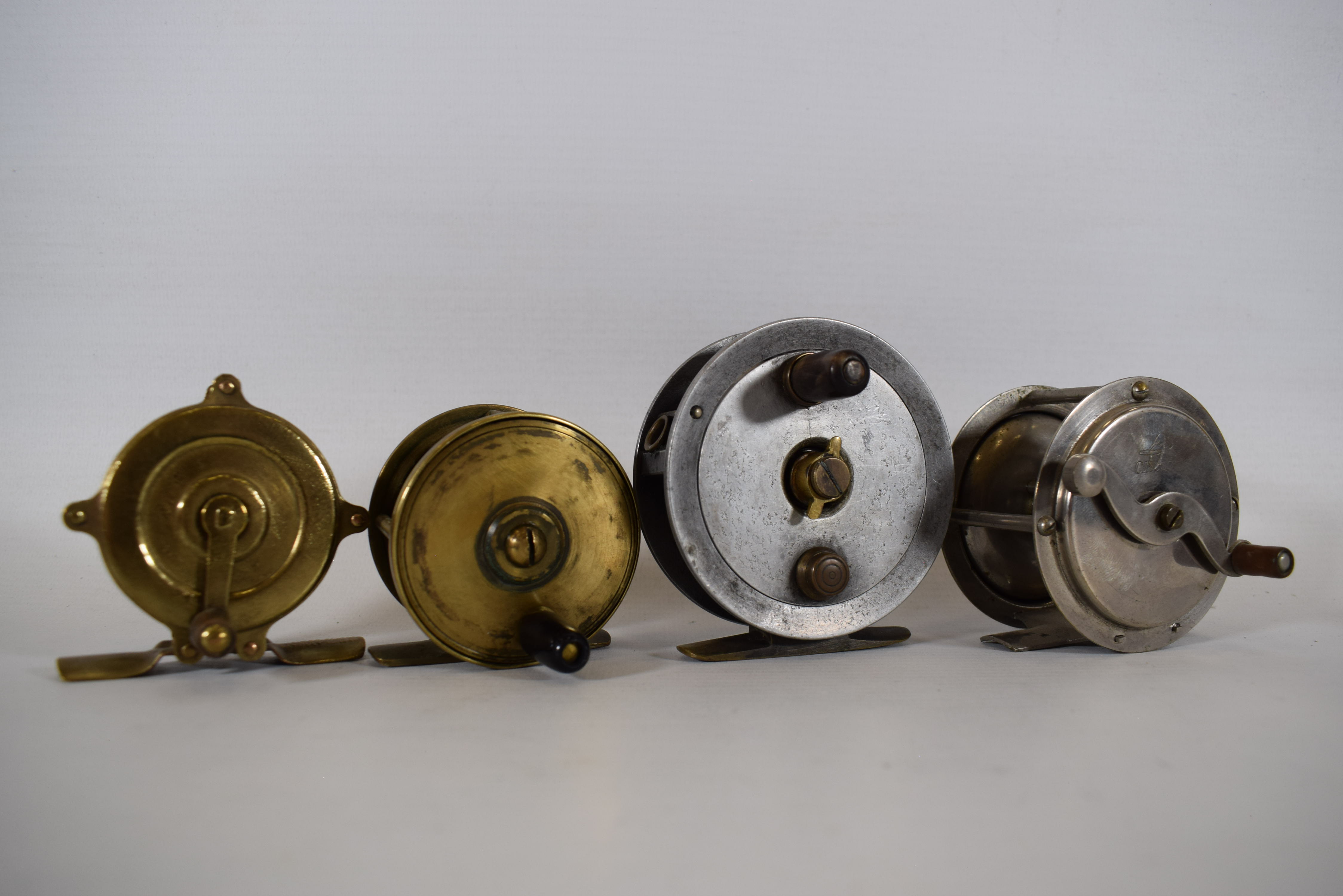 Four Fly Fishing reels of steel, brass and aluminium. See photos. 