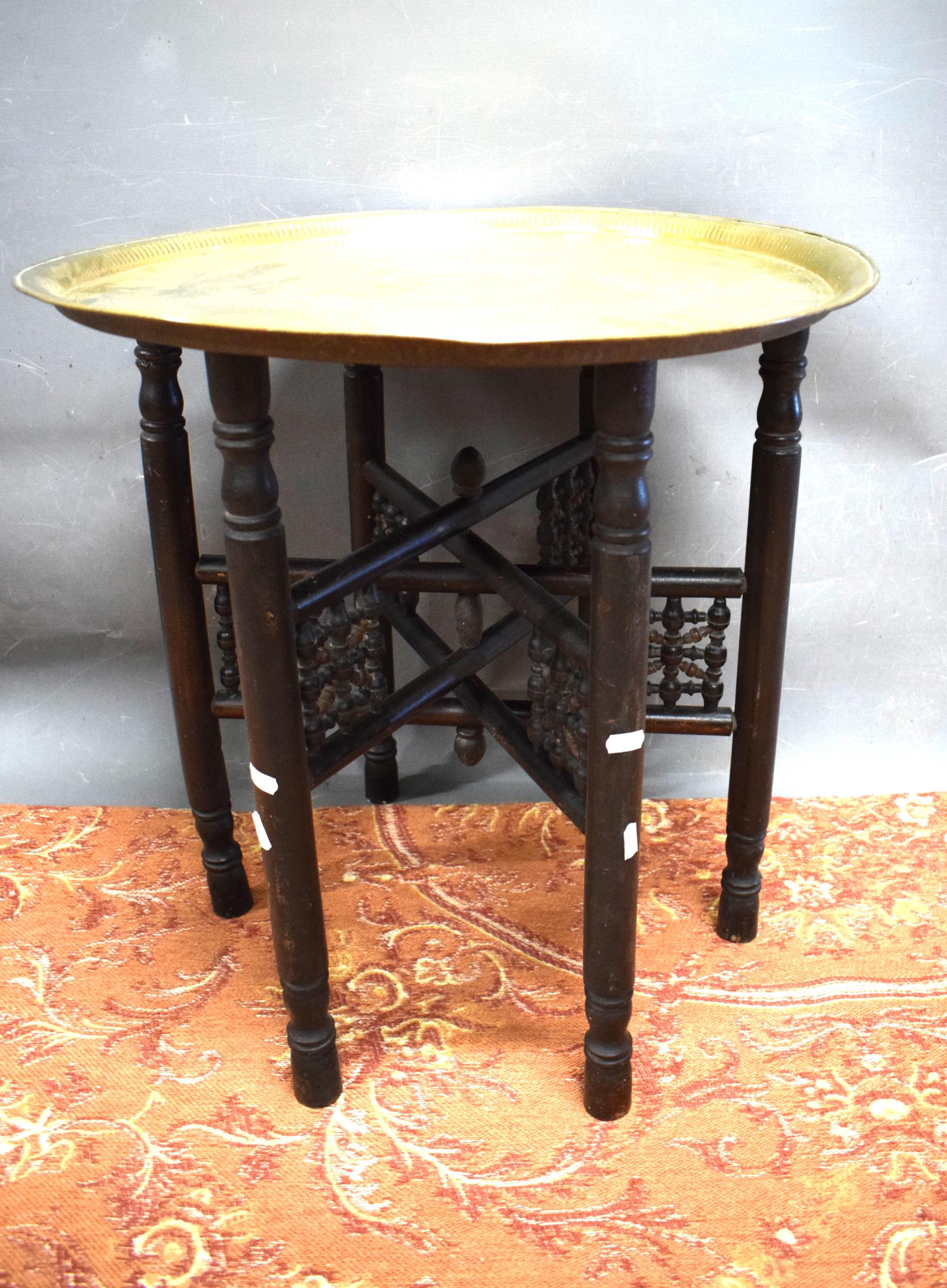 Folding wooden table plus detailed brass top    22 inches tall,  23 inches diameter. See photos.  S2