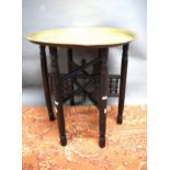 Folding wooden table plus detailed brass top    22 inches tall,  23 inches diameter. See photos.  S2