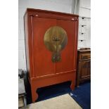 PA1126 Substantial Chinese made Wedding cabinet with brass Moon face panel to front twin doors,  Twi