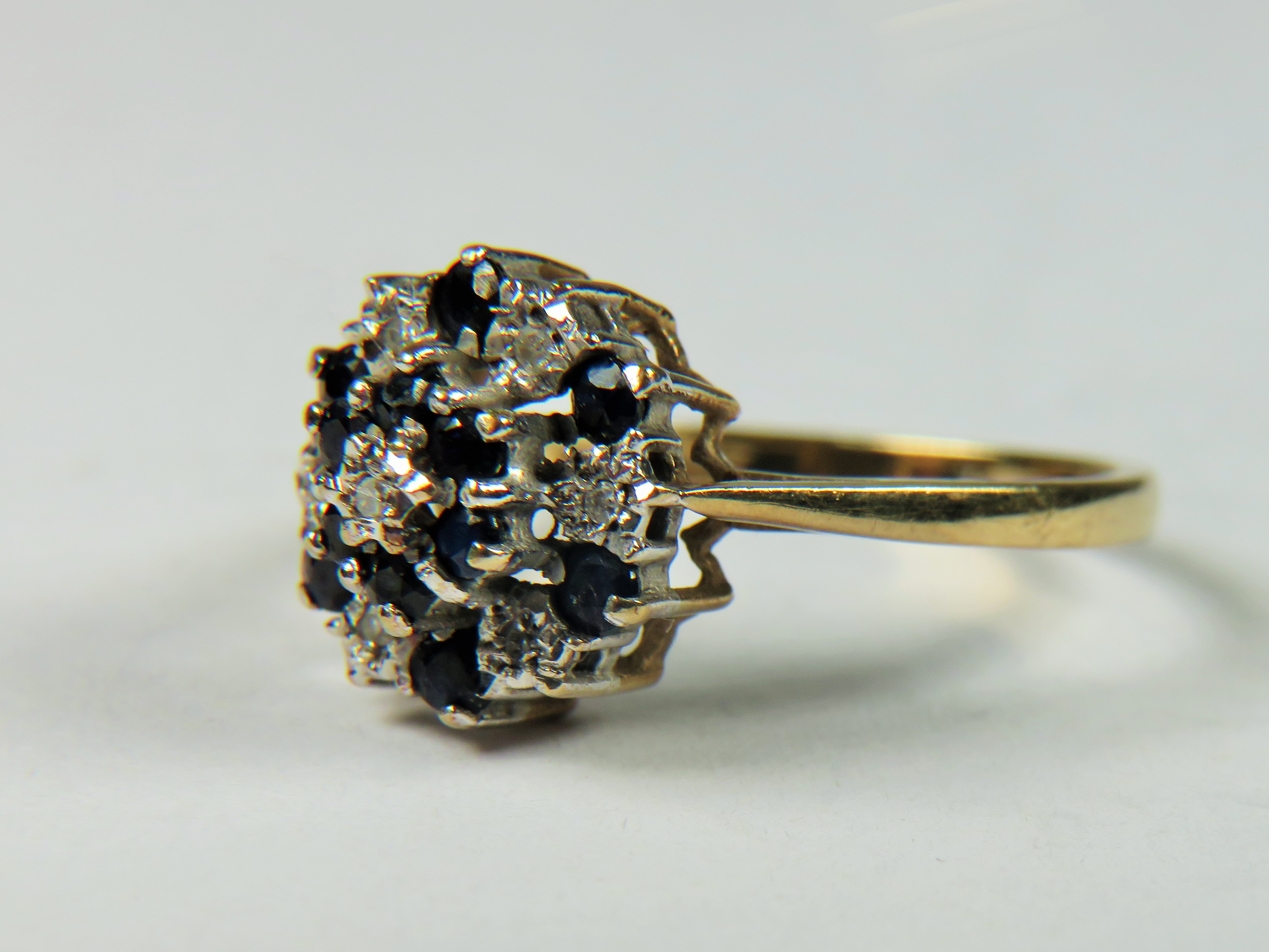 9ct Yellow Gold Diamond as Sapphire ring set in a Flower pattern.   Finger size 'M-5'   2.4g - Image 2 of 4