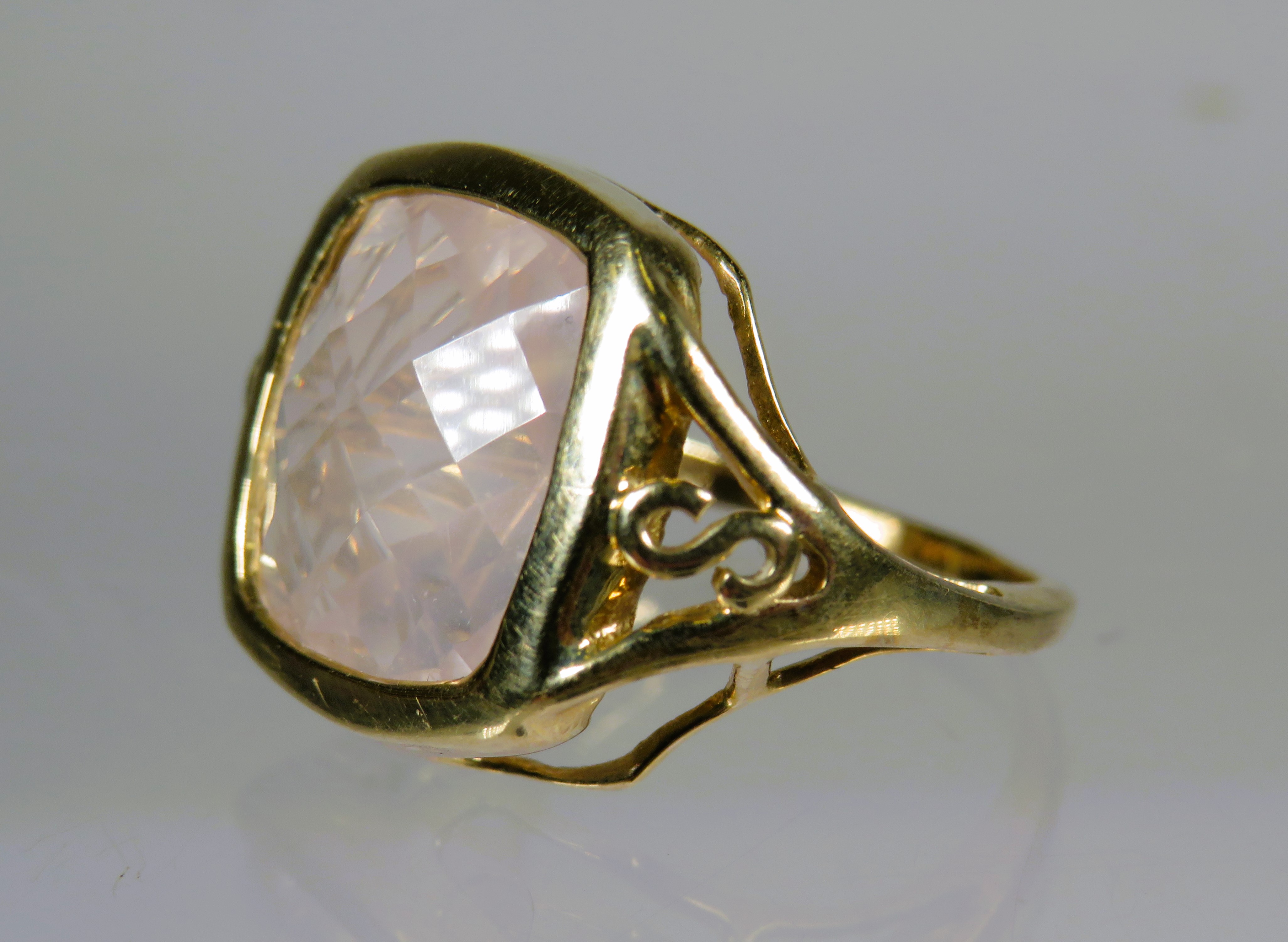 9ct Yellow Gold Ring set with a Square Cut Rose Quartz (12 x 12mm). Scrolled and pierced Shoulder.  
