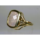 9ct Yellow Gold Ring set with a Square Cut Rose Quartz (12 x 12mm). Scrolled and pierced Shoulder.  