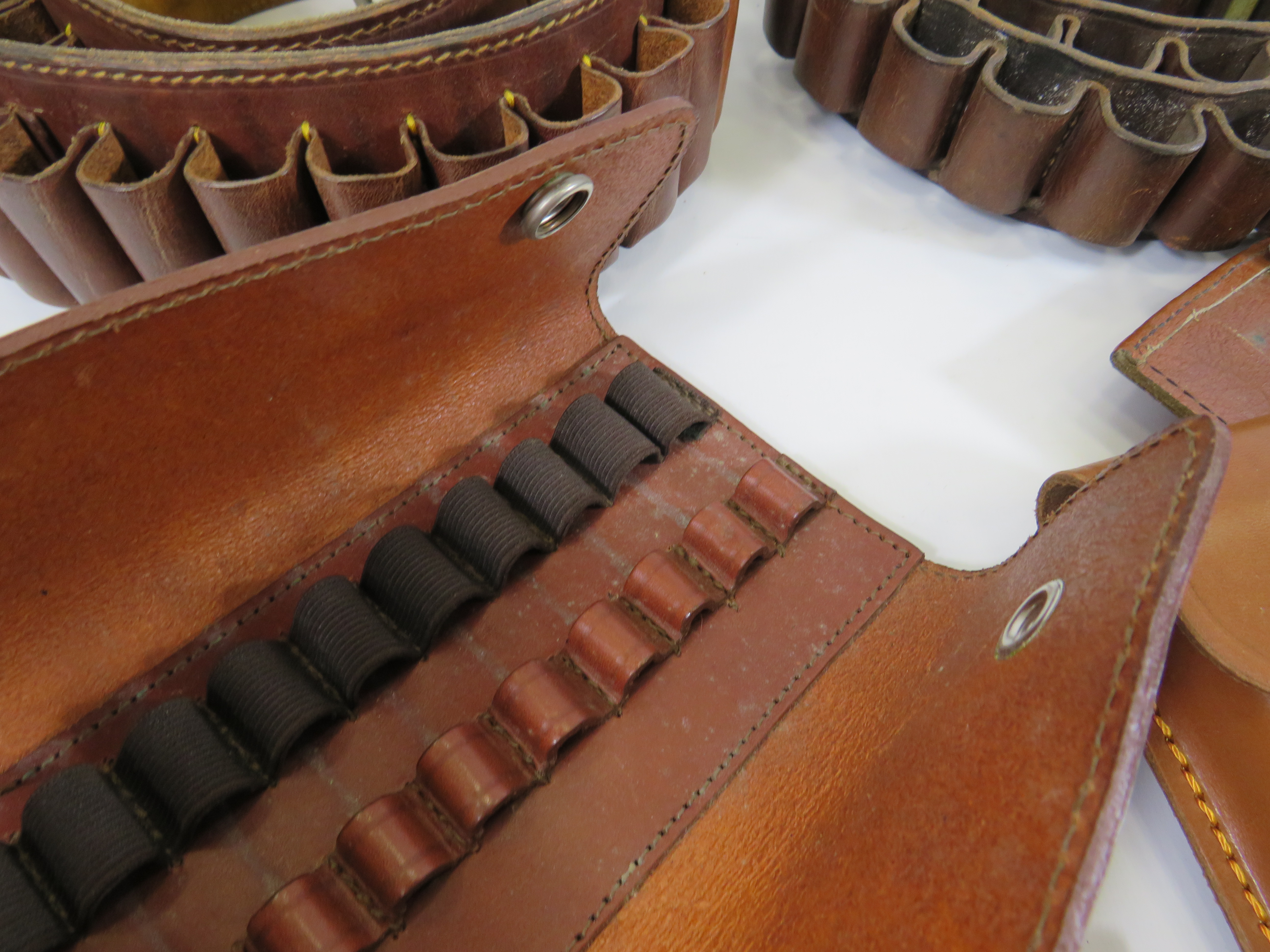 Two leather ammo belts and a selection of round holsters. - Image 3 of 3