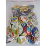 Selection of vintage birthday and advertising badges.