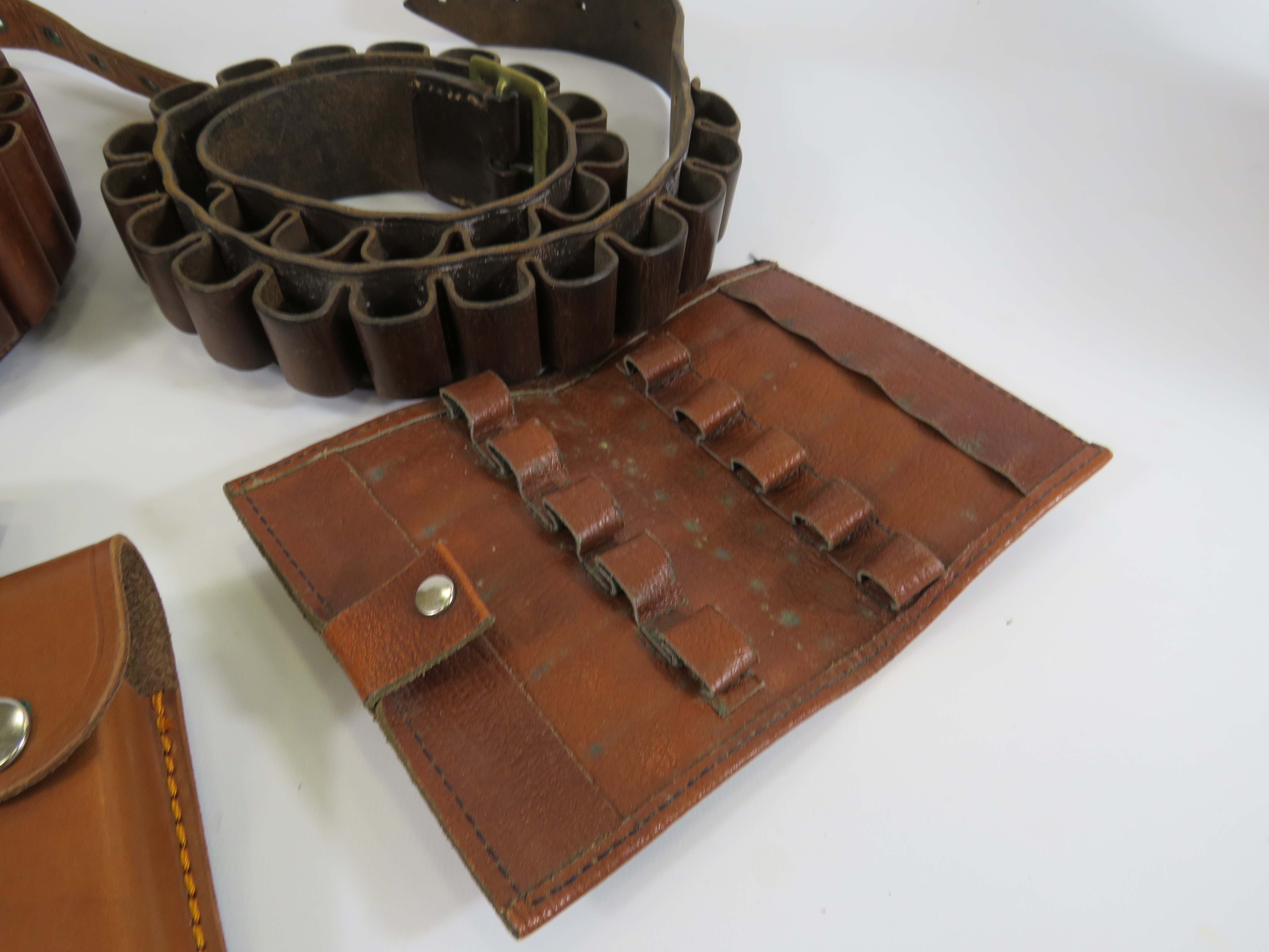 Two leather ammo belts and a selection of round holsters. - Image 2 of 3