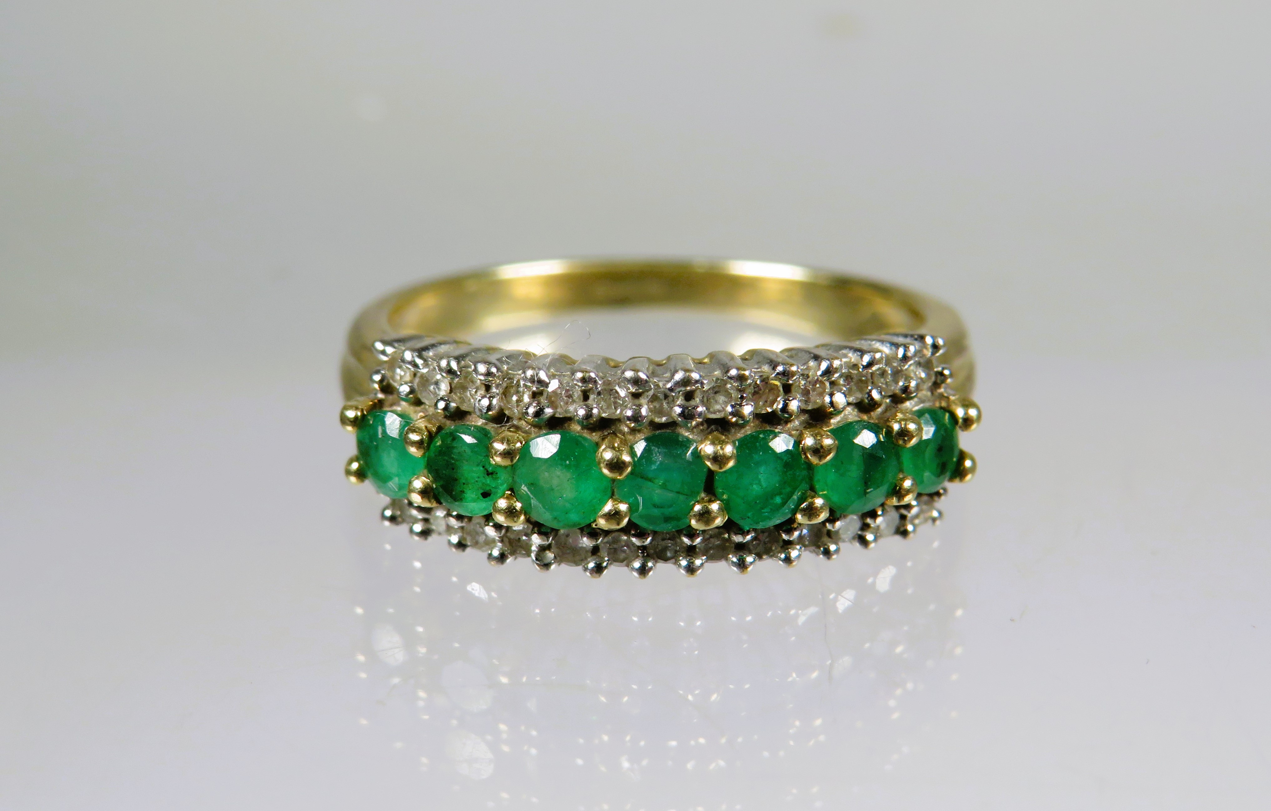 9ct Yellow Gold Ring set with Emerald Coloured CZ and Flanked by Twin rows of Melee Diamonds.  Finge