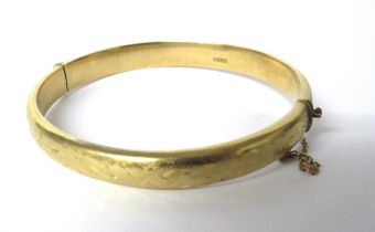 9Ct Yellow Gold etched Bangle with safety chain fitted. Weight 11.8g