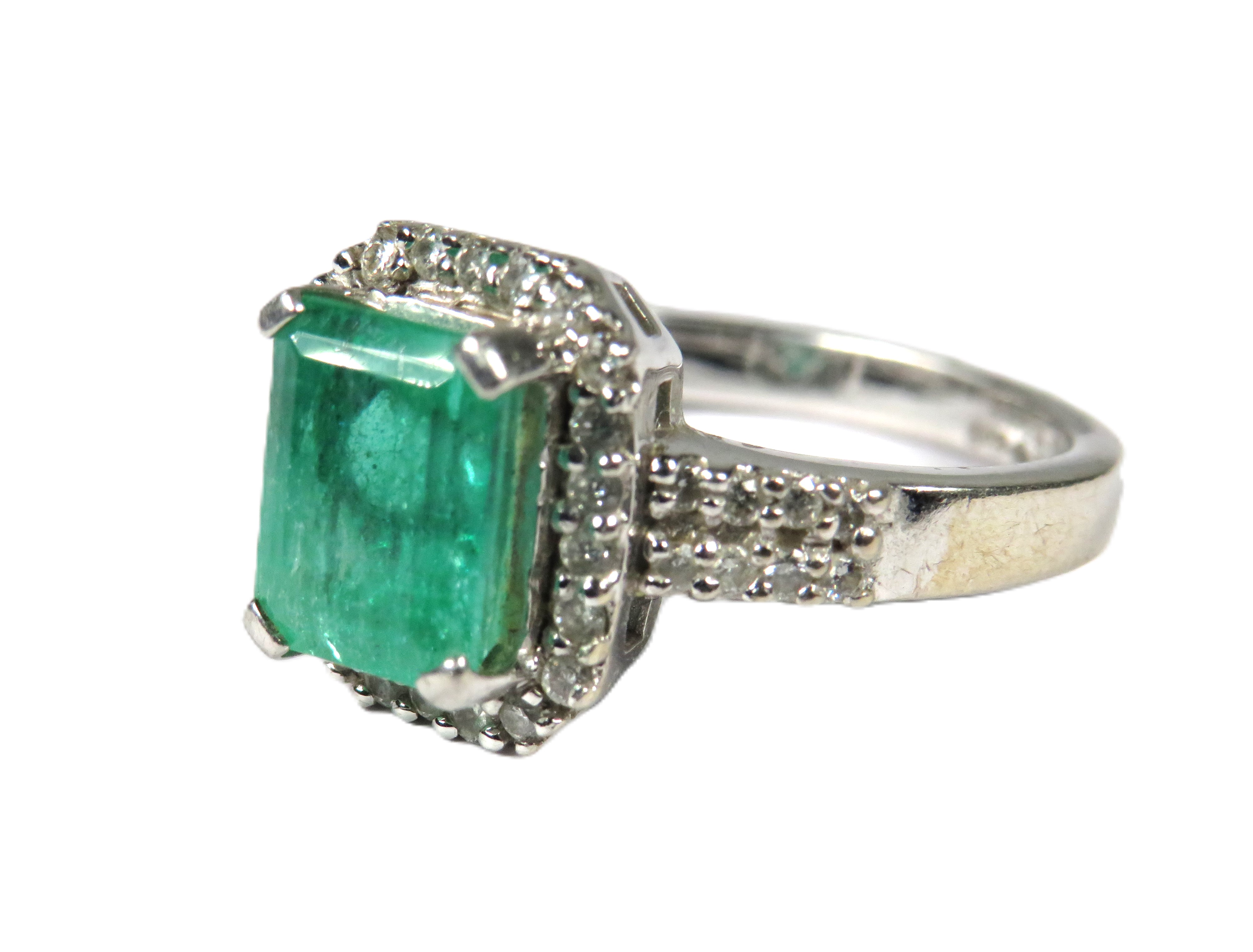 900 Platinum Ring set with a large Central Emerald of approx 2.16 cts and surrounded by Multiple Dia